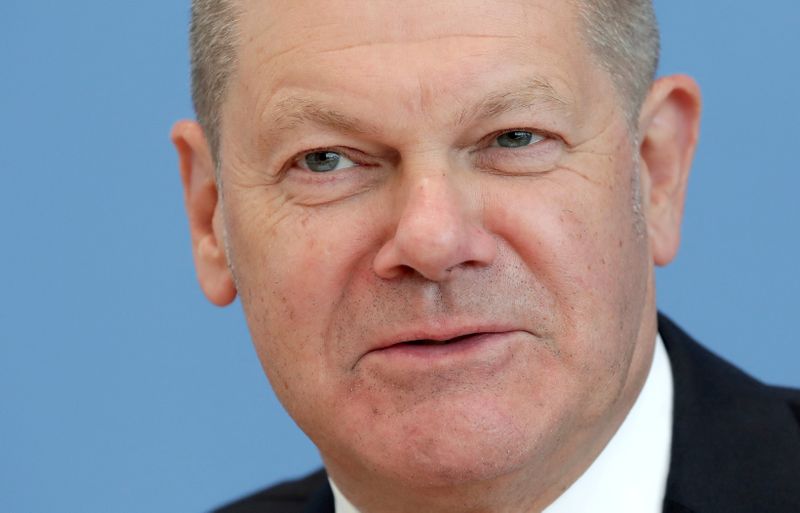 FILE PHOTO: German Finance Minister Olaf Scholz attends a news