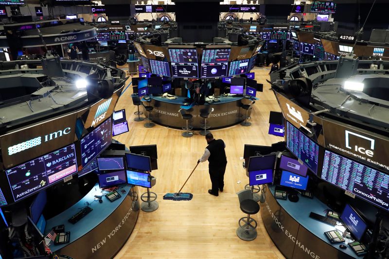 A man cleans up on the trading floor, following traders