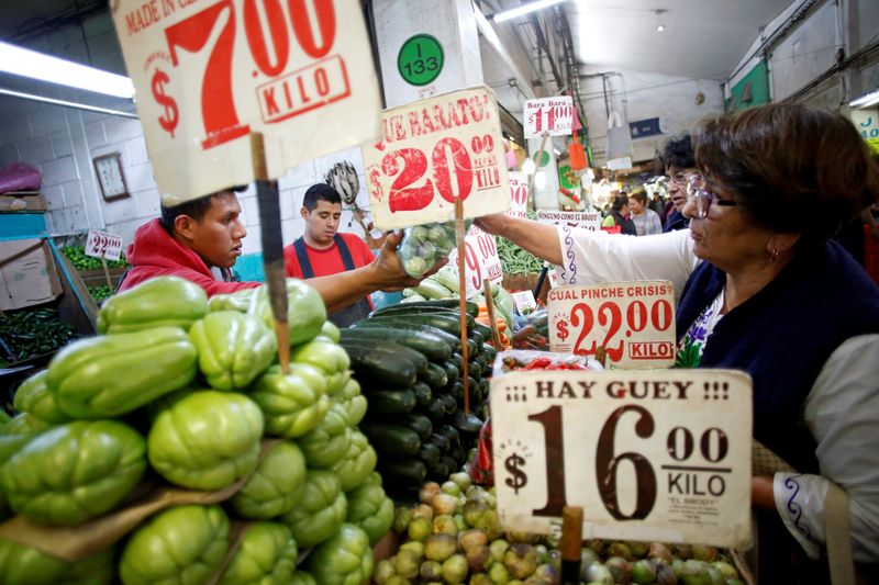 FILE PHOTO: A woman reaches for a bag of produce