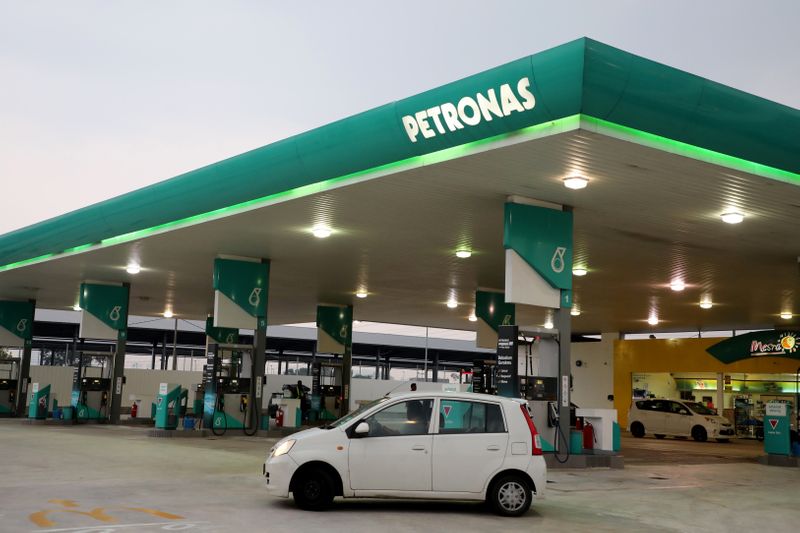 A car passes by a Petronas petrol station in Kuala
