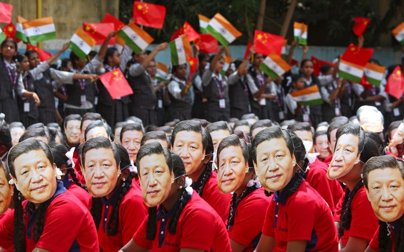 File photo of students wearing masks of China’s President Xi