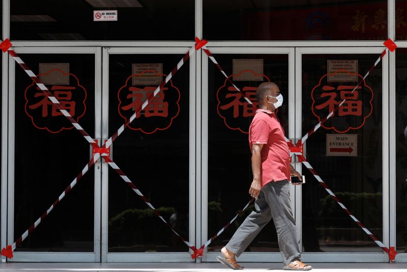 A man passes a closed off mall amid the coronavirus