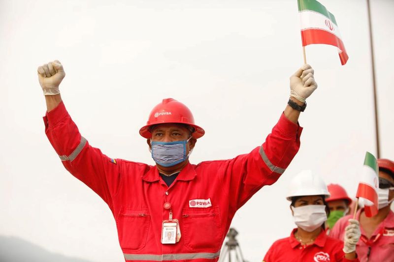 FILE PHOTO: A worker of the state-oil company Pdvsa holds
