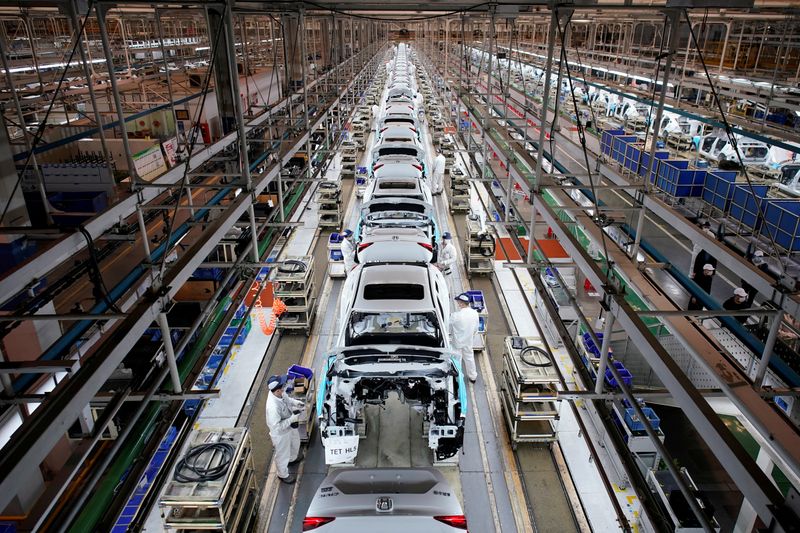 Employees work on a production line inside a Dongfeng Honda