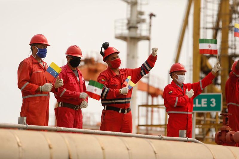 FILE PHOTO: Workers of the state-oil company Pdvsa holding Iranian