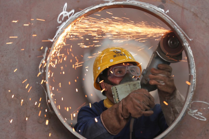 Employee works on a production line manufacturing steel structures at