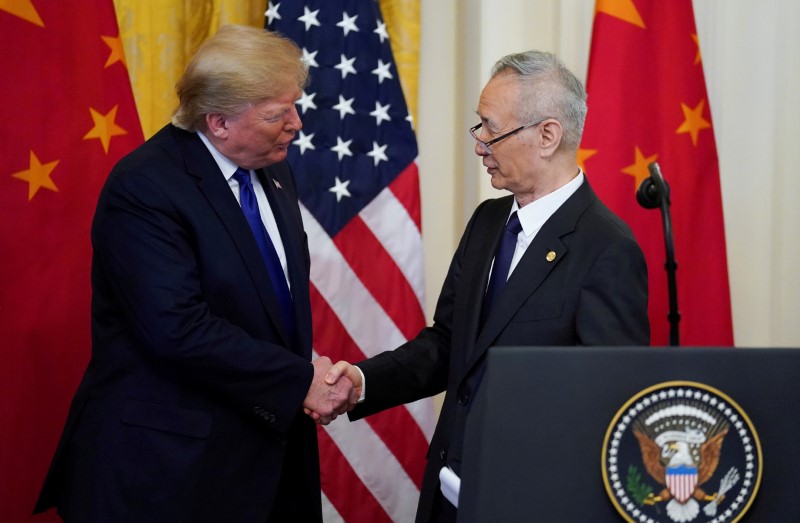 FILE PHOTO: U.S. President Donald Trump shakes hands with Chinese