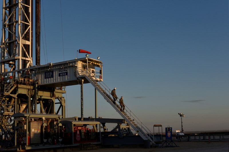 FILE PHOTO: A drilling crew leaves the rig at the