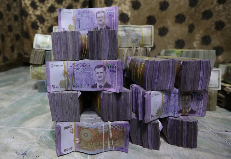 Syrian pounds are pictured inside an exchange currency shop in