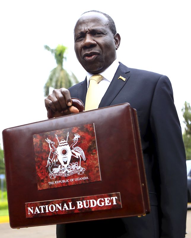 FILE PHOTO: Uganda Minister of Finance Kasaija displays a briefcase