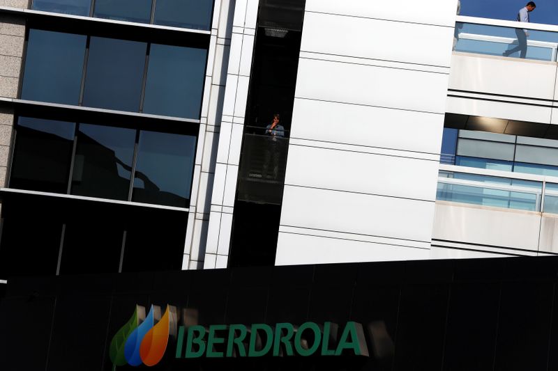 FILE PHOTO: A worker of Spanish power company Iberdrola smokes