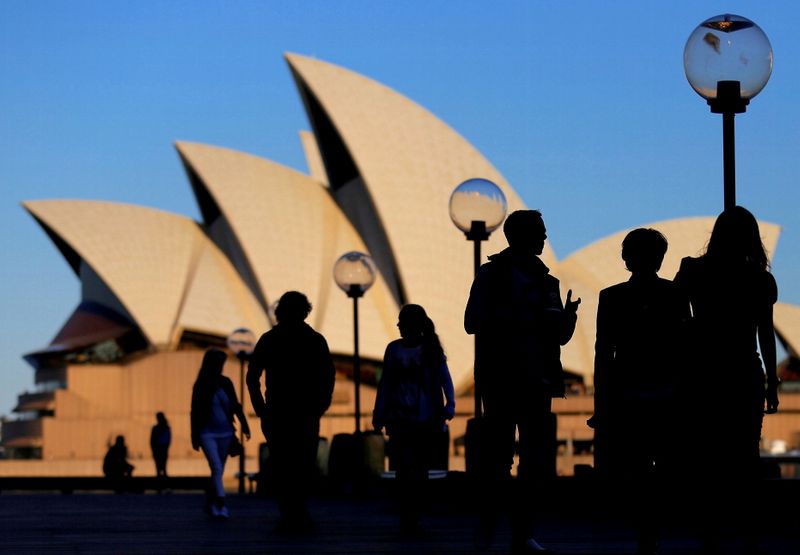 FILE PHOTO: People are silhouetted against the Sydney Opera House