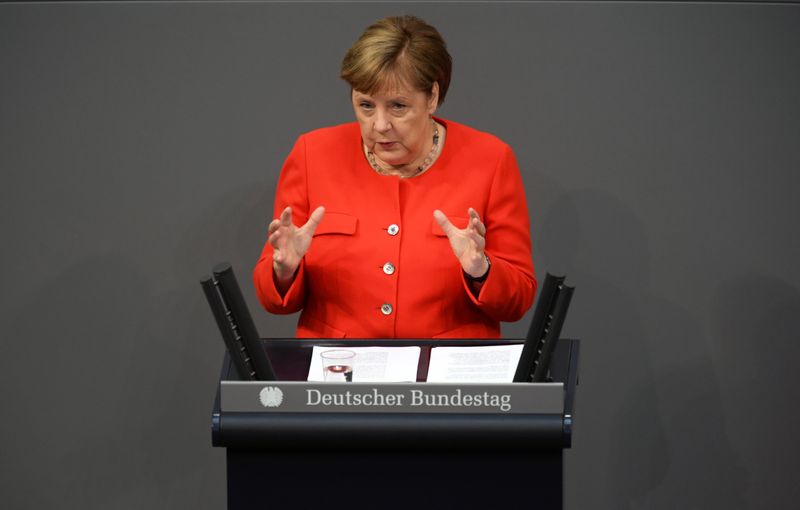 German Chancellor Angela Merkel addresses the lower house of parliament
