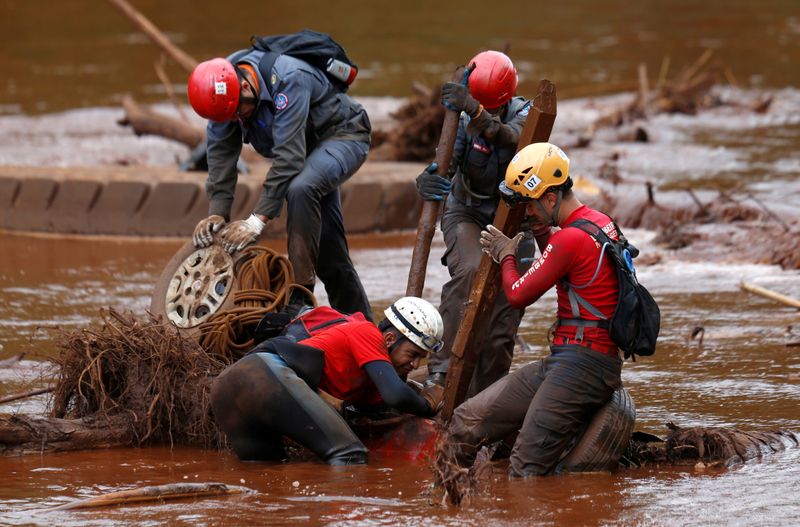 FILE PHOTO: Members of a rescue team search for victims
