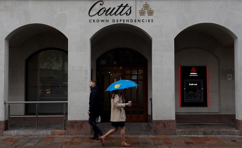 Pedestrians pass a branch of Coutts bank in St Helier,