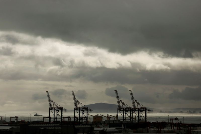 FILE PHOTO: Cranes are seen beneath stormy winter weather over
