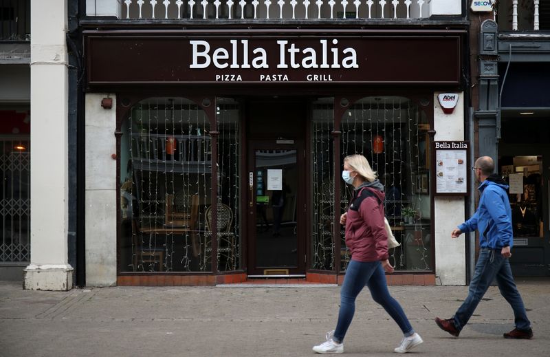 People walk by a Bella Italia restaurant in Chester