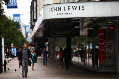 FILE PHOTO: A man walks past the John Lewis &