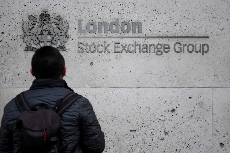 FILE PHOTO: A pedestrian in front of the London Stock