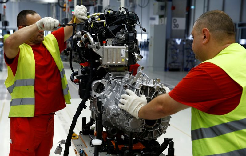 Workers work on a new Volkswagen Crafter diesel engine EA