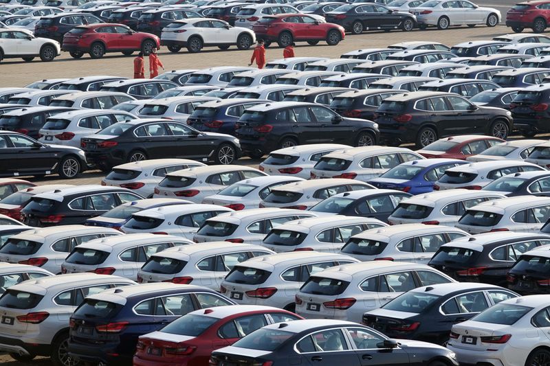 Newly manufactured cars are seen at a port in Dalian