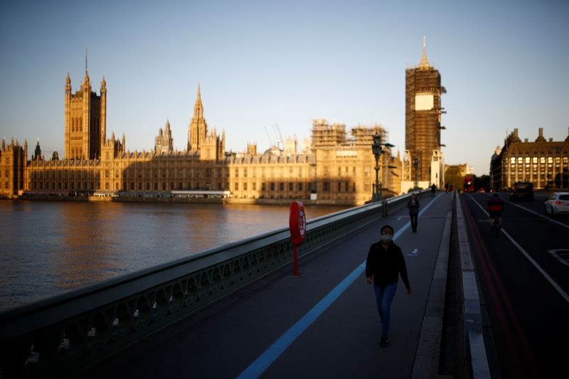 FILE PHOTO: People walk on Westminster bridge in front of