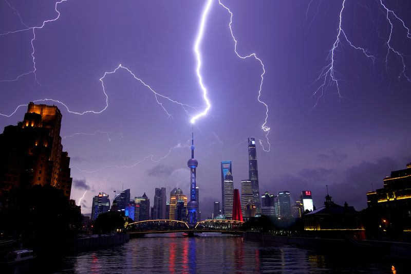 FILE PHOTO: Lightning strikes are seen above the skyline of