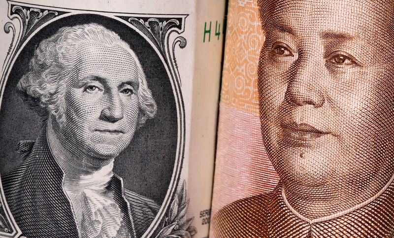 Chinese Yuan and U.S. dollar banknotes are seen in this