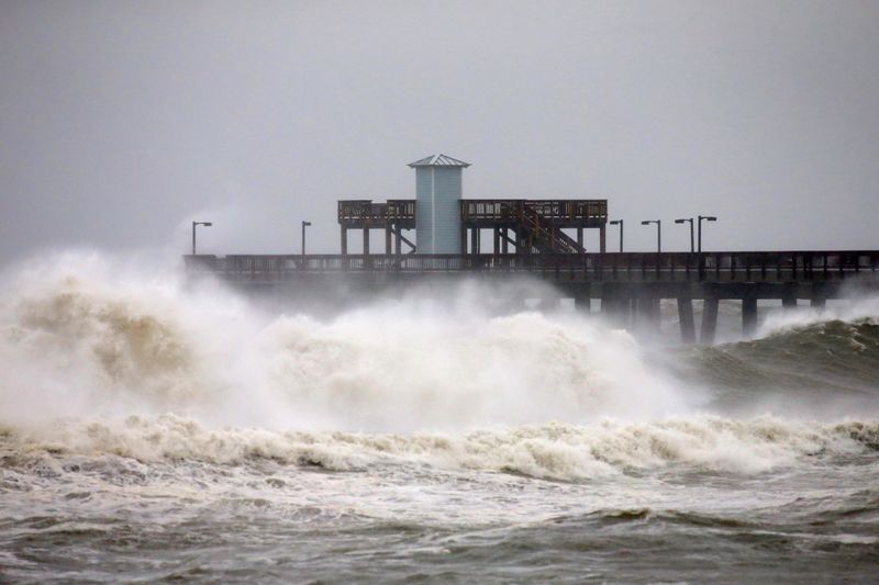 FILE PHOTO: Waves crash along a pier as Hurricane Sally