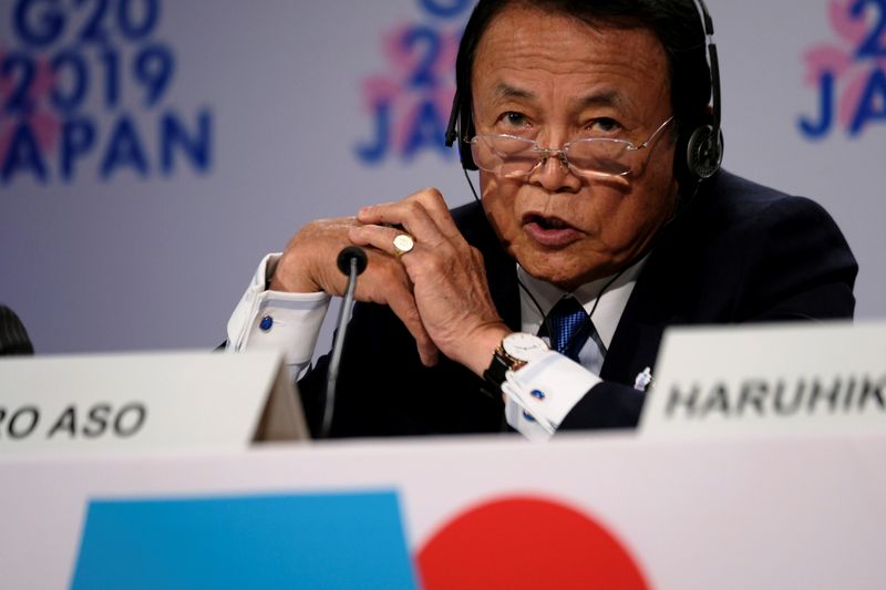 Japanese Finance Minister Taro Aso takes questions from reporters at