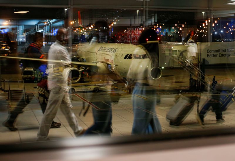 Passengers’ reflections are seen in a terminal window with a