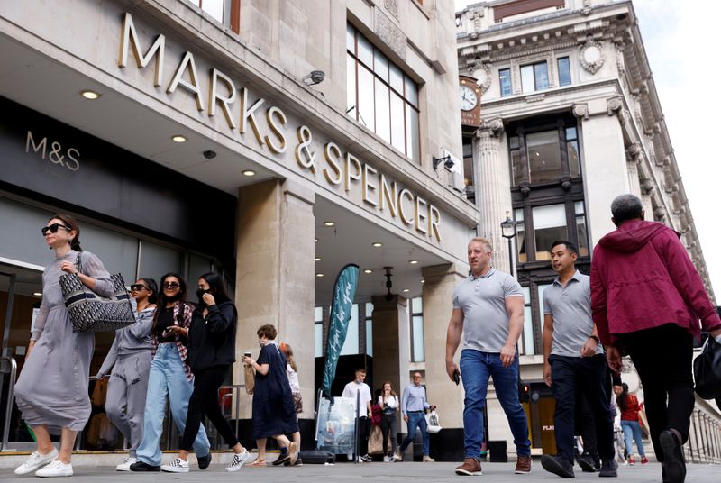 FILE PHOTO: People walk outside the Marks&Spencer shop amid the