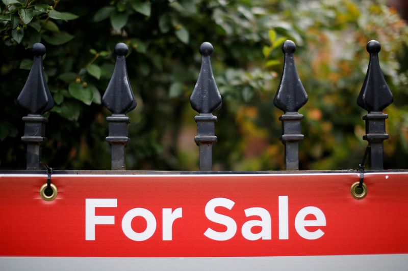 FILE PHOTO: A real estate sign is seen hanging on