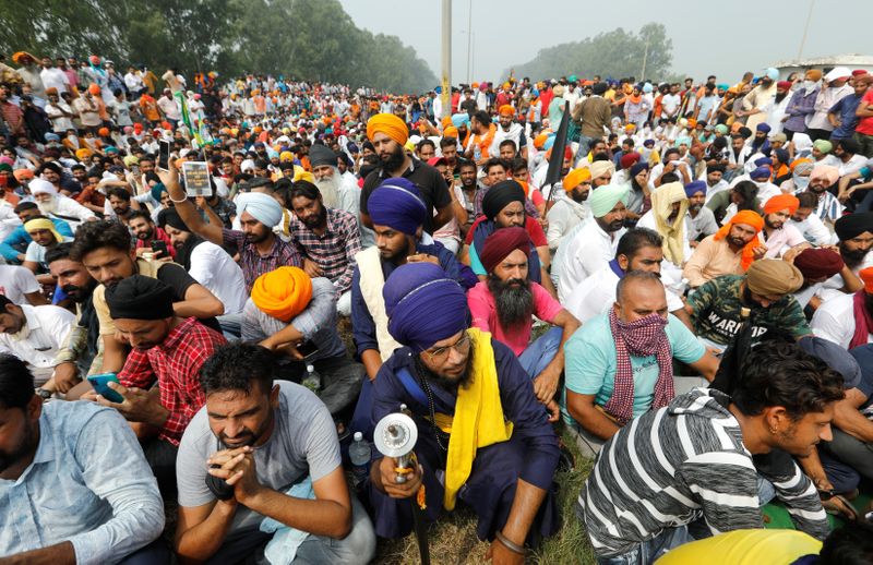 FILE PHOTO: Farmers sit on a road as they block