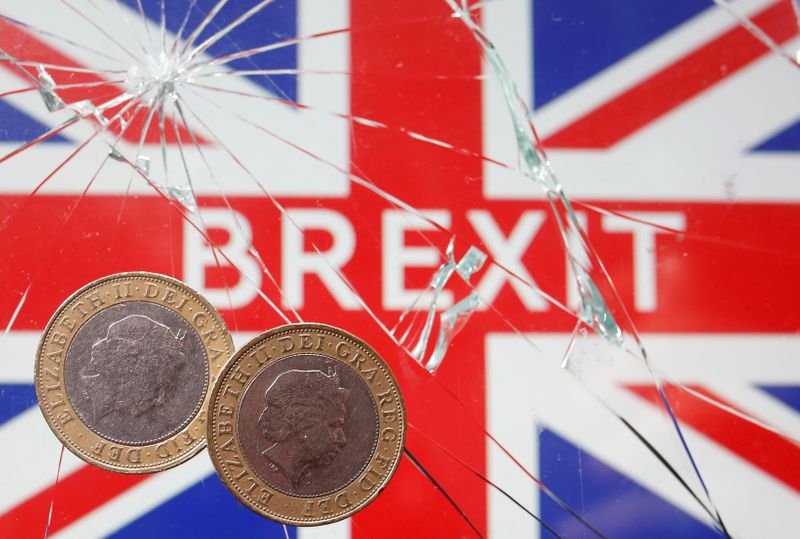 FILE PHOTO: Pound coins are placed on broken glass and
