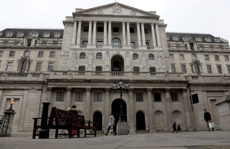 People walk in front of the Bank of England, as