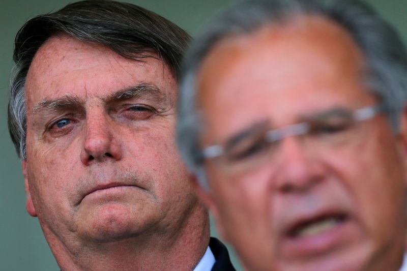 Brazil’s President Jair Bolsonaro and Economy Minister Paulo Guedes attend