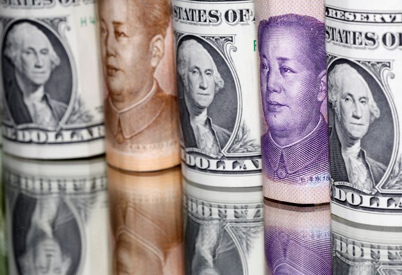 FILE PHOTO: Chinese Yuan and U.S. dollar banknotes are seen