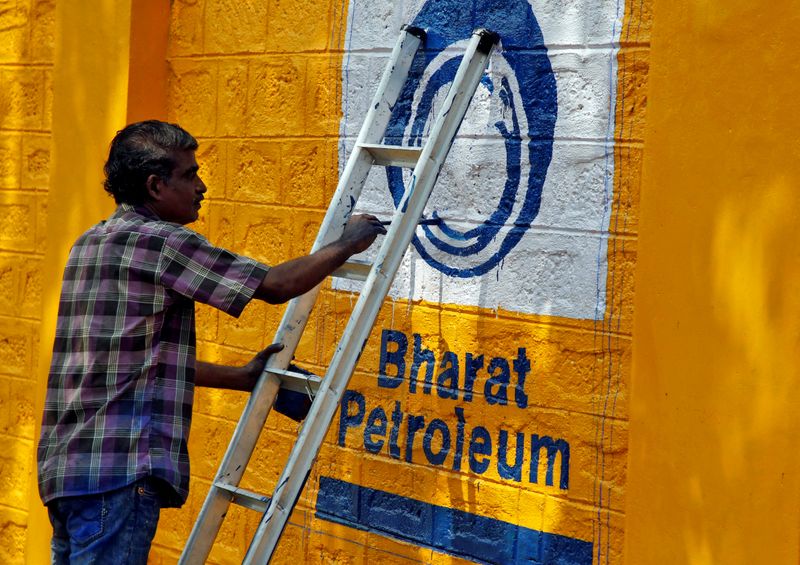 FILE PHOTO: A man paints the logo of oil refiner