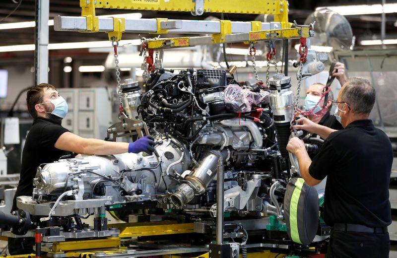 FILE PHOTO: Technicians work on a Rolls-Royce engine prior to
