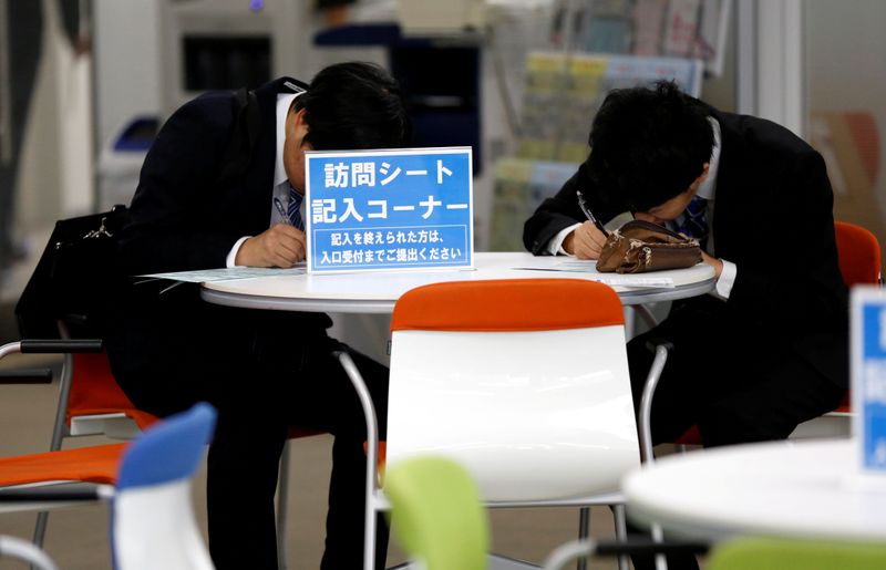 FILE PHOTO: Job seekers attend a job fair held for