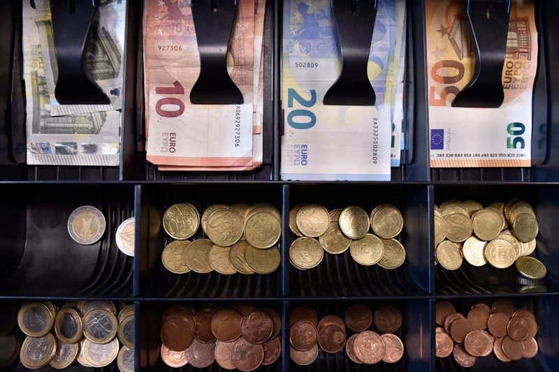 Euro banknotes and coins are displayed in a shop in