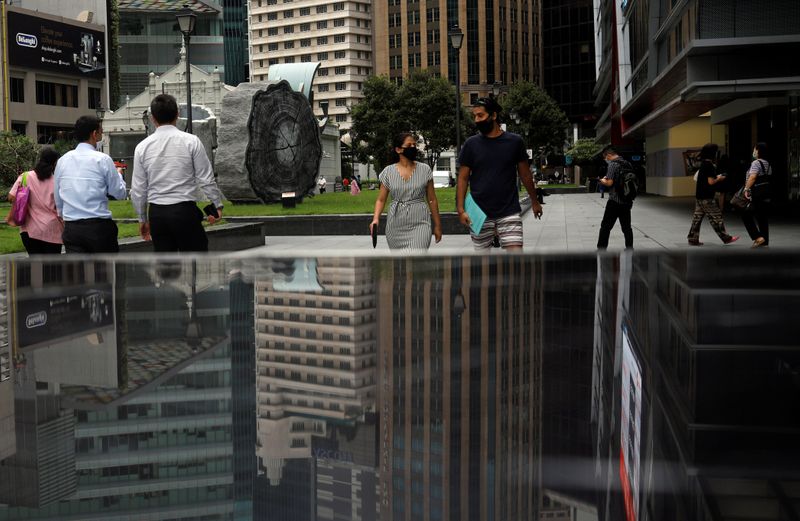 FILE PHOTO: People walk at the central business district in