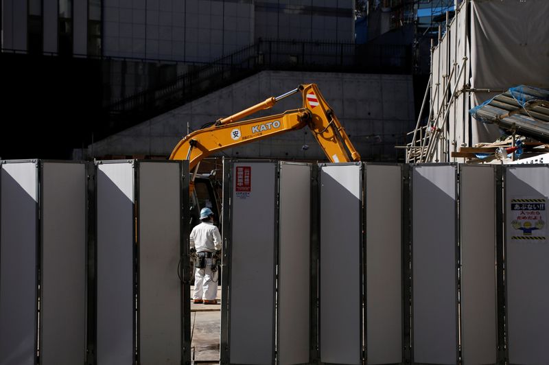 A worker is pictured next to heavy machinery at a