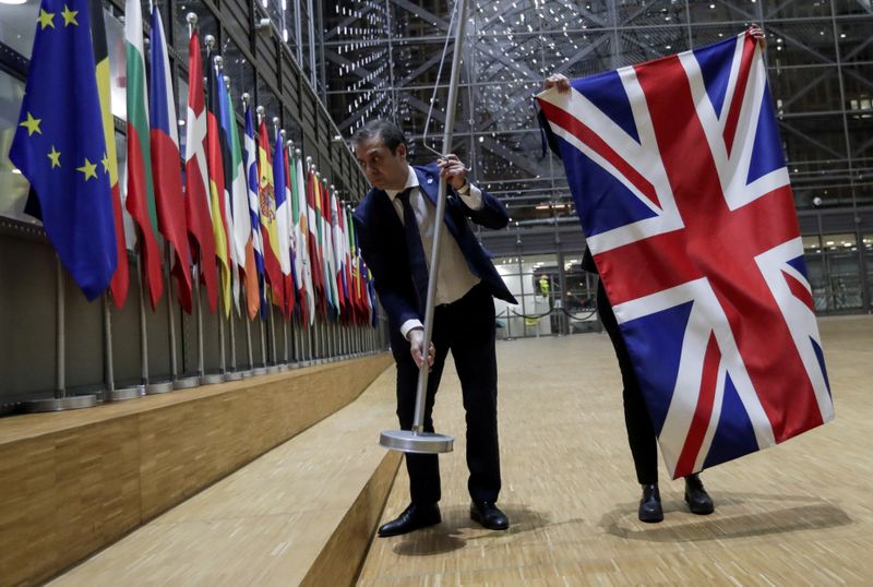 FILE PHOTO: Officials remove the British flag at EU Council
