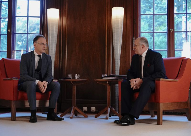 German Foreign Minister Heiko Maas chats with Polish counterpart Zbigniew