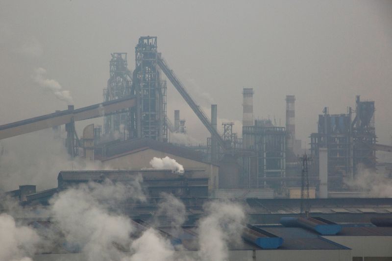 FILE PHOTO: Smoke and steam rise from a steel plant