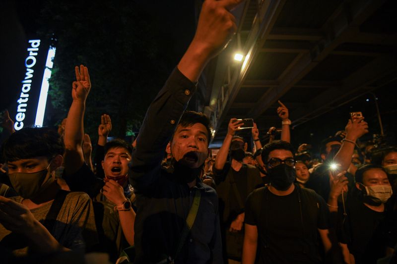 People show the three-finger salute during a gathering of pro-democracy