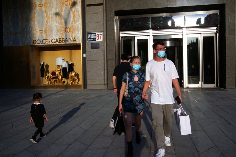 FILE PHOTO: People wearing face masks following the COVID-19 outbreak