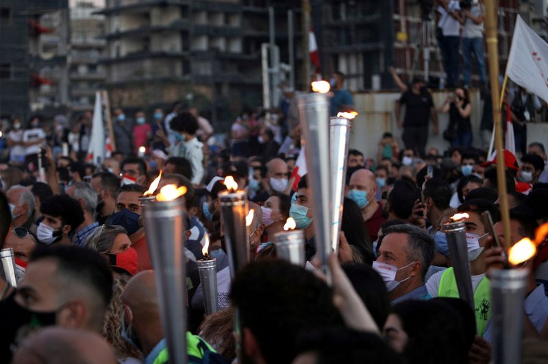 FILE PHOTO: People carry torches during a demonstration marking one